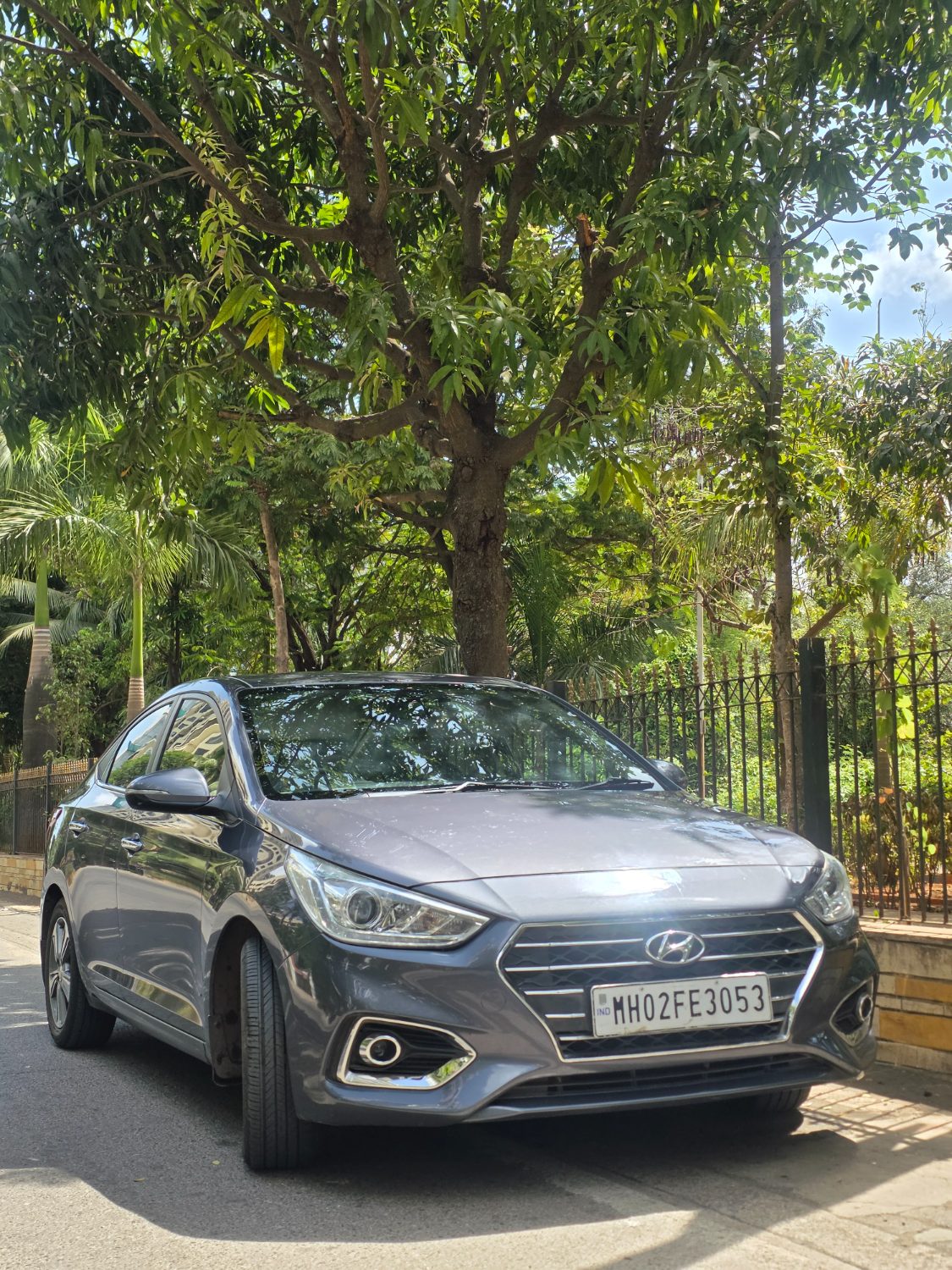White Hyundai Verna sedan parked on a Mumbai road